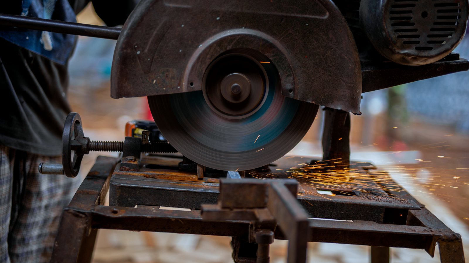 Bench chop saw cutting through metal section