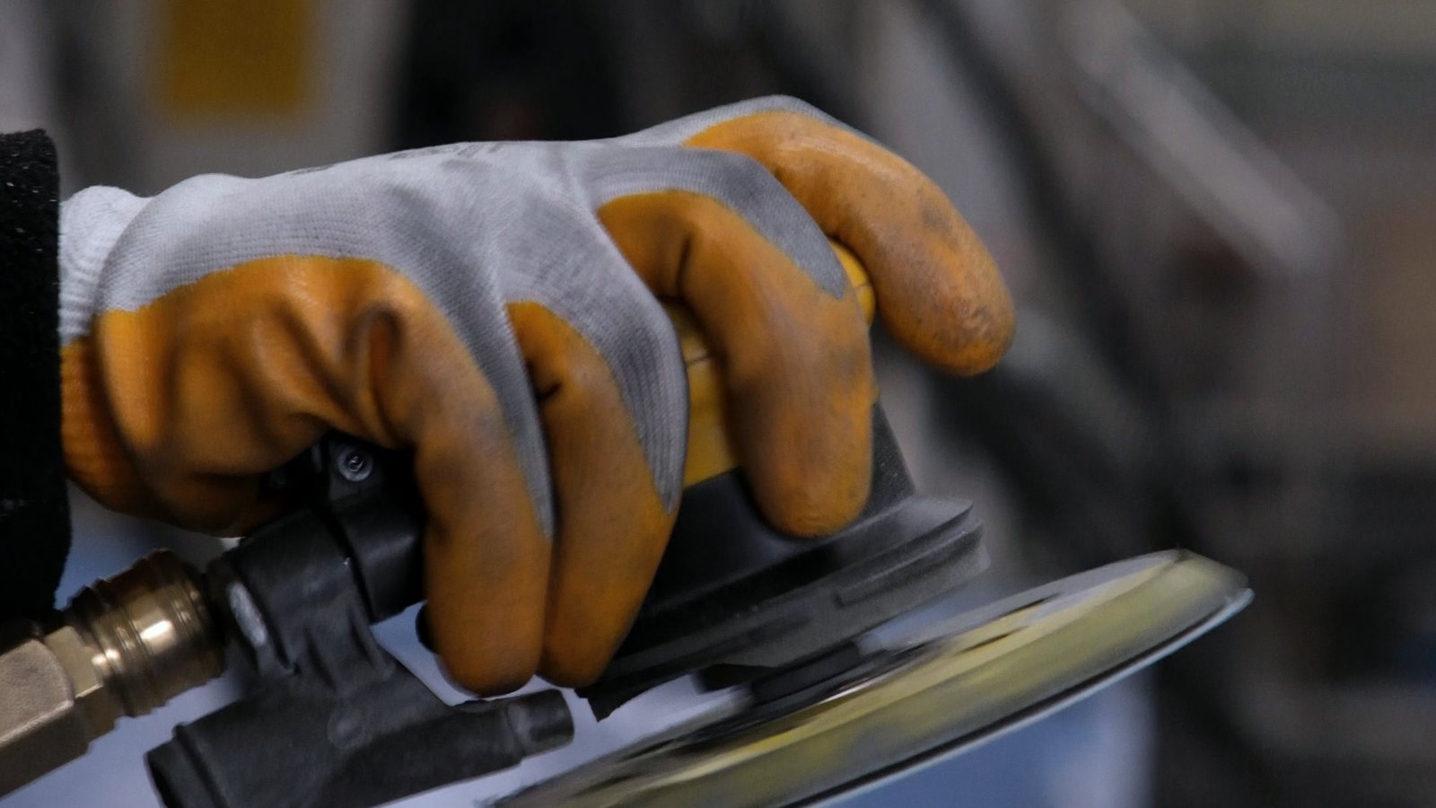 Pneumatic sander in use with the air line connected